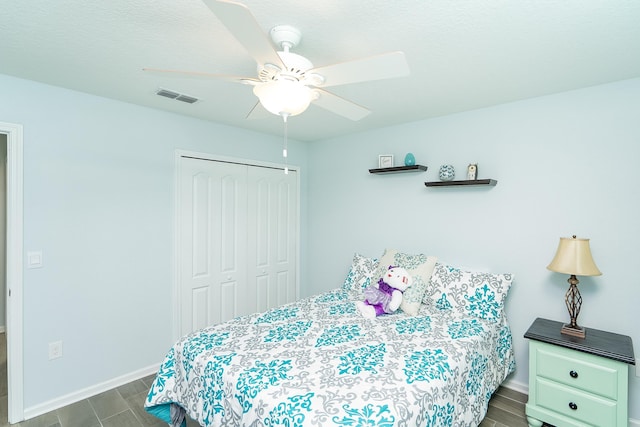 bedroom with ceiling fan, a closet, and dark hardwood / wood-style floors