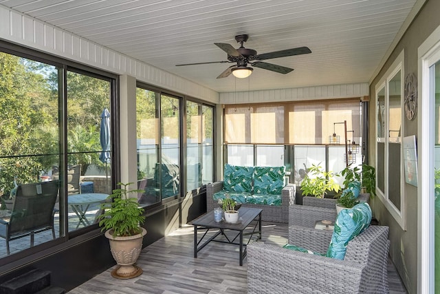 sunroom featuring a ceiling fan