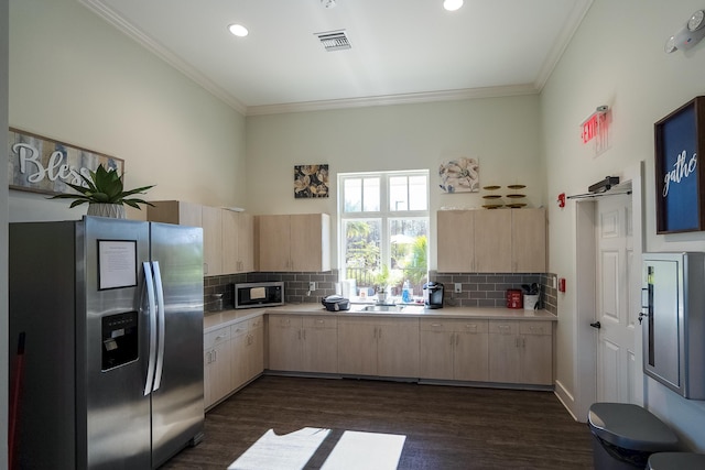 kitchen with light brown cabinetry, a sink, stainless steel appliances, crown molding, and light countertops