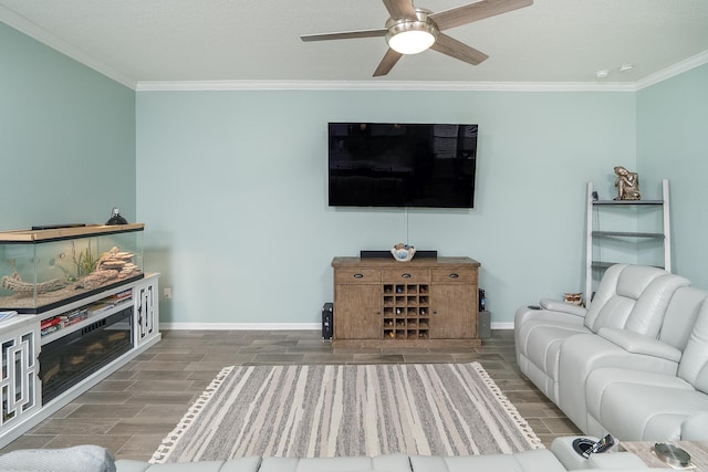 living room with hardwood / wood-style floors, ceiling fan, and crown molding