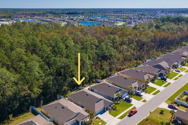 aerial view featuring a residential view, a forest view, and a water view