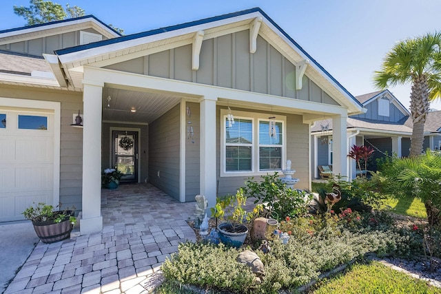 property entrance featuring board and batten siding and a garage