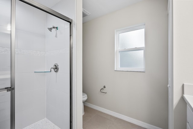 bathroom featuring tile patterned flooring, an enclosed shower, and toilet