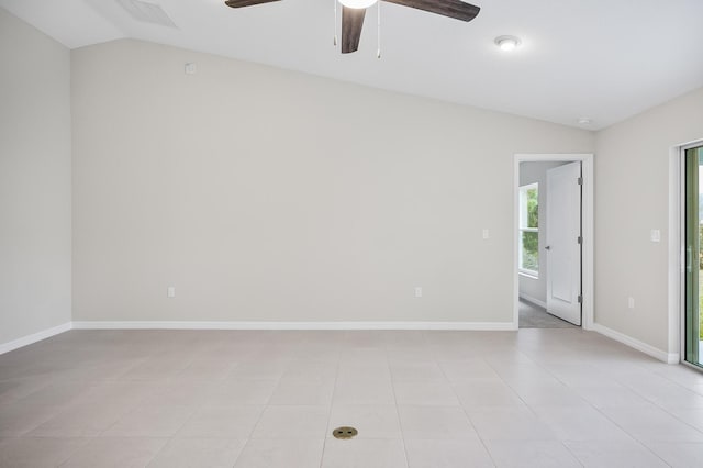 tiled empty room featuring vaulted ceiling and ceiling fan