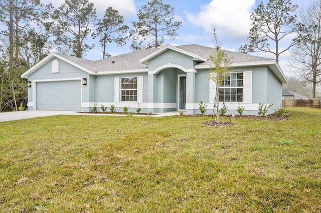 ranch-style home featuring a garage and a front lawn