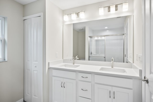 bathroom with a shower with door and vanity