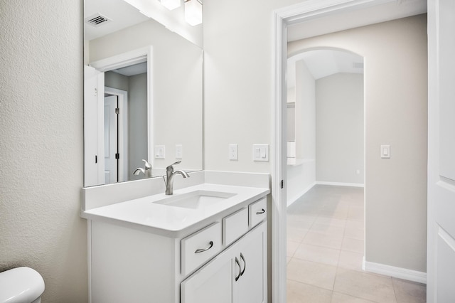 bathroom featuring vanity, toilet, and tile patterned flooring