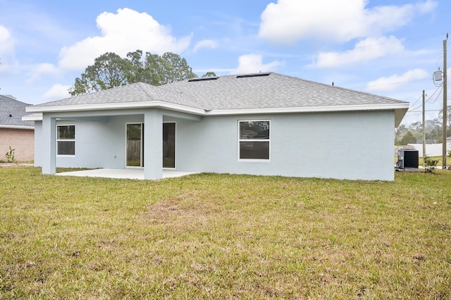 rear view of house with a yard, a patio area, and central air condition unit