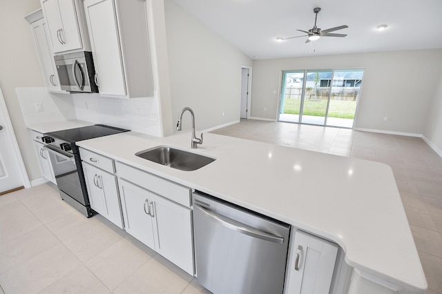 kitchen featuring sink, backsplash, stainless steel appliances, and white cabinets