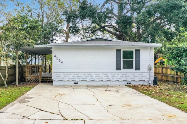 view of home's exterior featuring a wooden deck and a carport