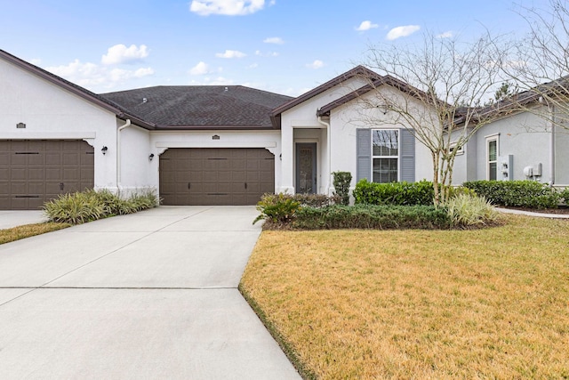 ranch-style house featuring a garage and a front lawn