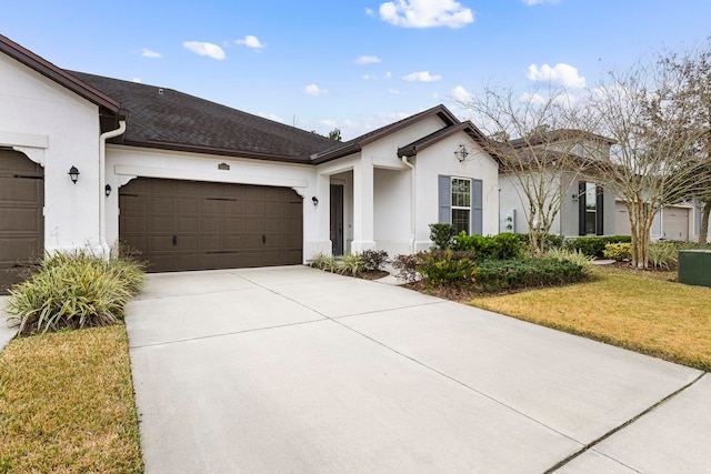 single story home featuring a garage and a front yard