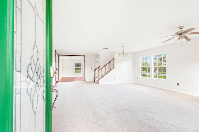 4905 Cypress Links Blvd, Elkton, FL 32033 - foyer entrance featuring a chandelier, stairs, carpet floors, and ceiling fan