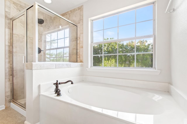 bathroom with tile patterned floors and independent shower and bath