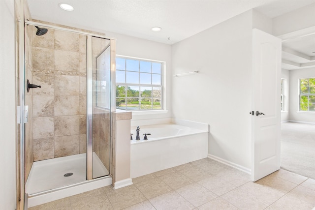 bathroom featuring a healthy amount of sunlight and shower with separate bathtub