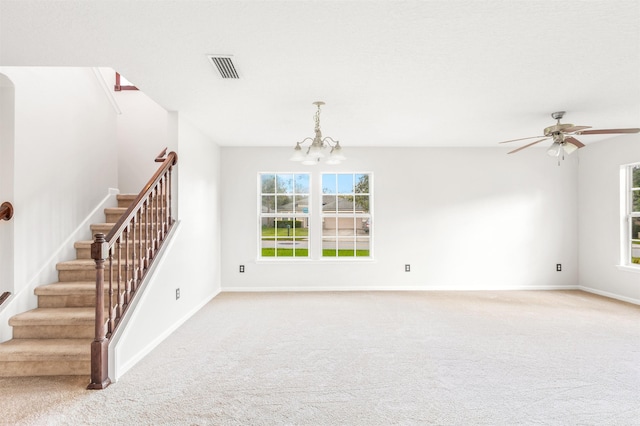 empty room featuring light carpet and ceiling fan with notable chandelier