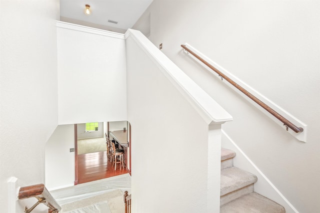 stairs featuring hardwood / wood-style floors