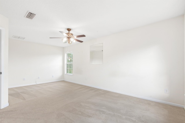 unfurnished room with light colored carpet and ceiling fan