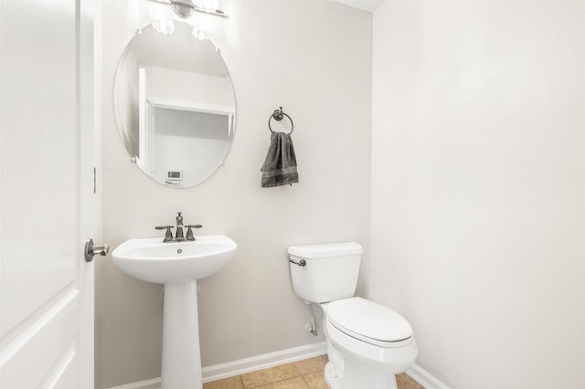 bathroom with tile patterned flooring, toilet, and sink