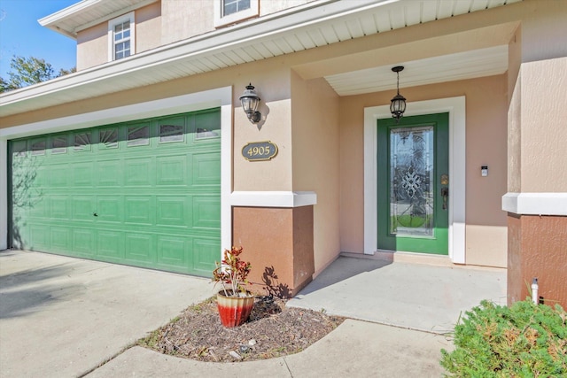 4905 Cypress Links Blvd, Elkton, FL 32033 - property entrance featuring a garage, stucco siding, and driveway