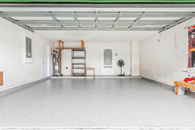 garage featuring electric panel and water heater