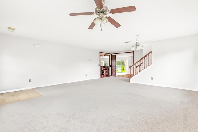 4905 Cypress Links Blvd, Elkton, FL 32033 - unfurnished living room with carpet floors, stairs, a chandelier, and a ceiling fan