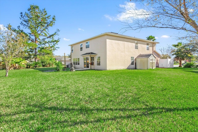 rear view of property with a storage shed and a lawn