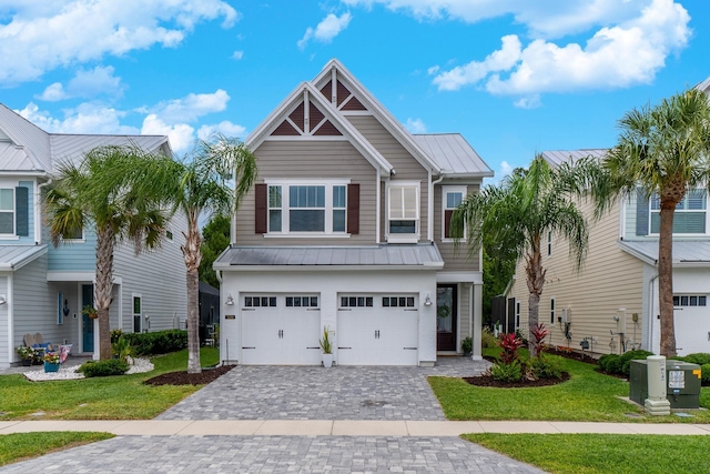 view of front of property with a front lawn and a garage