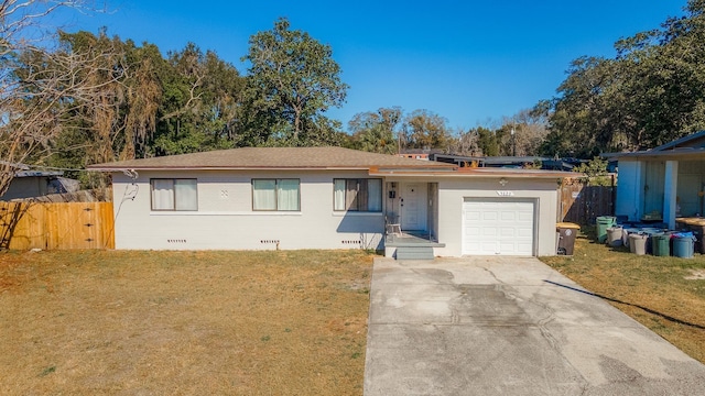 ranch-style home featuring a garage, fence, concrete driveway, crawl space, and a front lawn