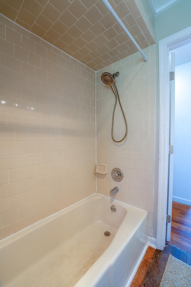 full bathroom with washtub / shower combination and baseboards