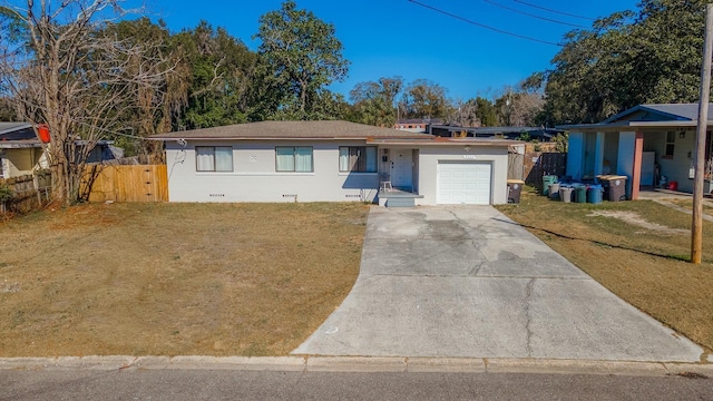 ranch-style home with a garage, fence, driveway, a gate, and a front lawn