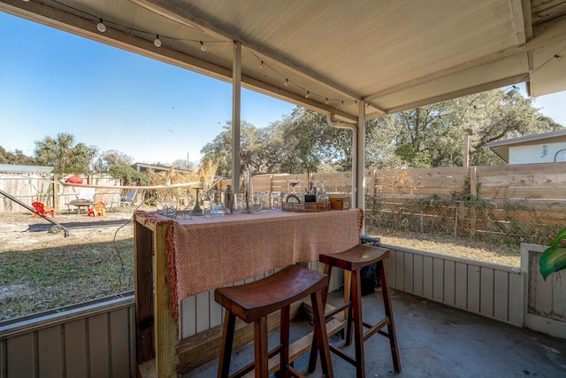 view of patio / terrace featuring outdoor dry bar and a fenced backyard