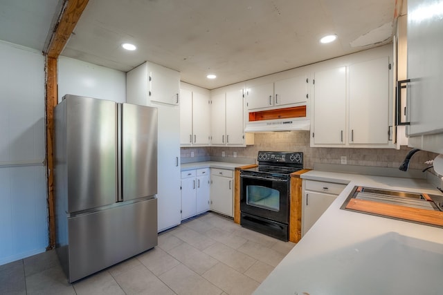 kitchen with light countertops, freestanding refrigerator, a sink, under cabinet range hood, and black / electric stove