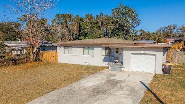 single story home featuring a garage, fence, driveway, and a front lawn