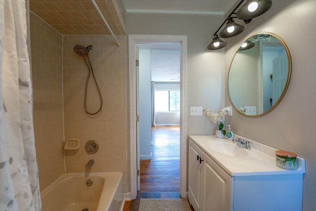 full bathroom with baseboards, ornamental molding, wood finished floors, shower / bath combination with curtain, and vanity