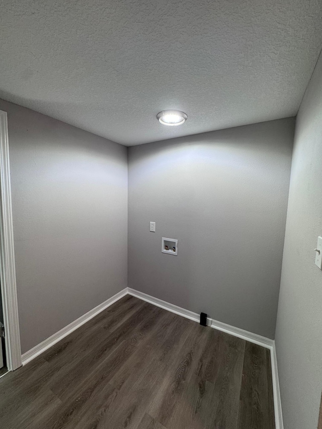 unfurnished room featuring dark hardwood / wood-style flooring and a textured ceiling