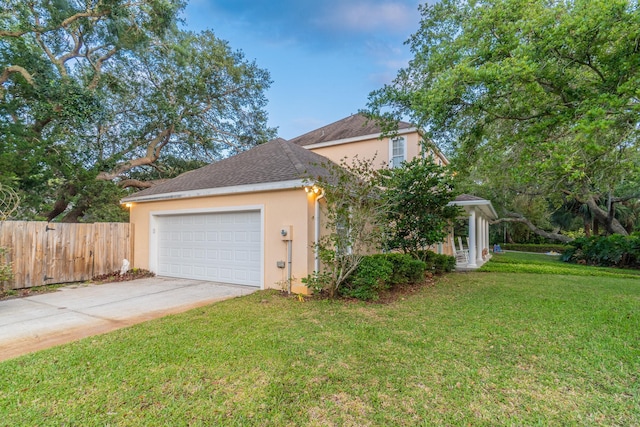 view of side of home with a yard and a garage