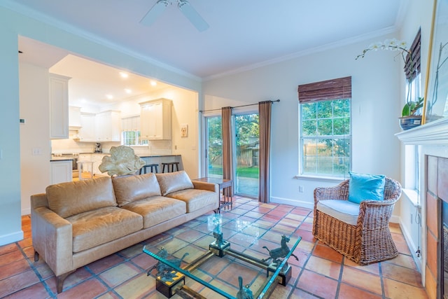 living room featuring a fireplace, ceiling fan, and ornamental molding