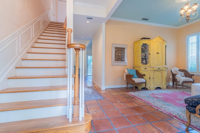 stairs featuring an inviting chandelier and ornamental molding