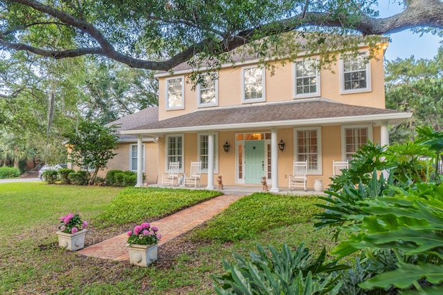 view of front of home featuring a porch and a front lawn