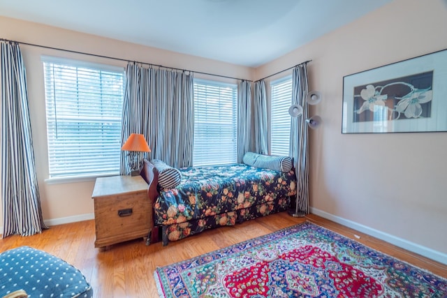 bedroom featuring multiple windows and hardwood / wood-style floors