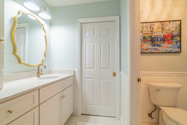 bathroom featuring vanity and toilet