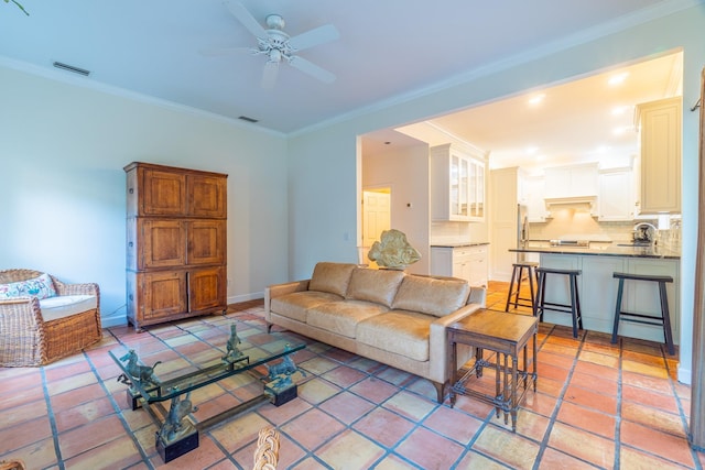 living room featuring ceiling fan and ornamental molding