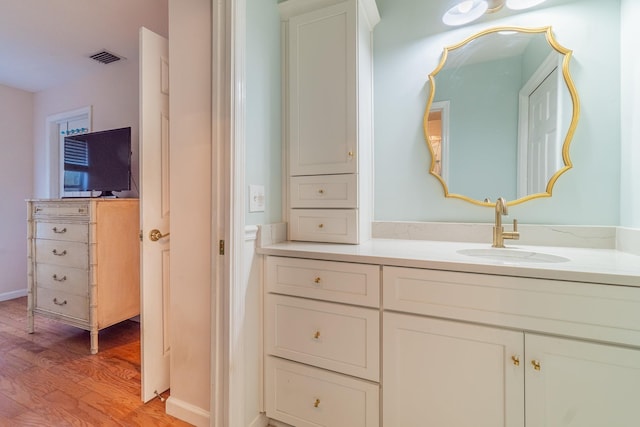 bathroom featuring hardwood / wood-style floors and vanity