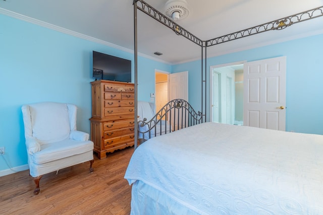 bedroom featuring hardwood / wood-style flooring and ornamental molding