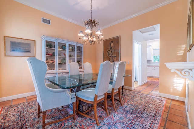 tiled dining room with an inviting chandelier and ornamental molding