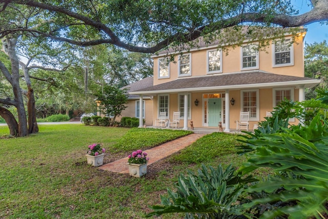 view of front of house featuring covered porch and a front lawn