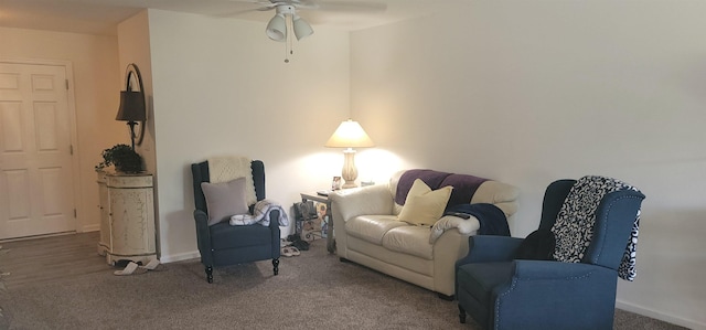 living room featuring ceiling fan and carpet