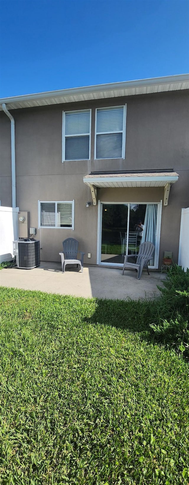 back of house featuring cooling unit and a patio