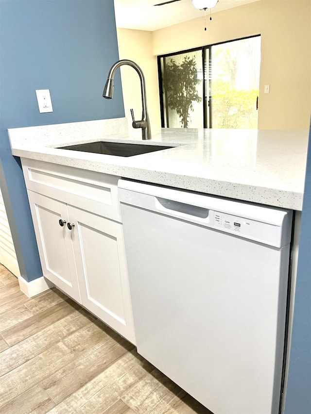 9 Alcira Ct, Saint Augustine, FL 32086 - kitchen with a sink, white cabinetry, white dishwasher, and light wood-style floors